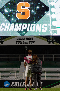 Up for their ninth national title, the Indiana Hoosiers lose to the Orange 2(7)-2(6) in overtime. Senior Karsen Henderlong, one of Indiana’s forwards, watched the scoreboard light up with the Syracuse logo while being comforted on Indiana’s loss. 