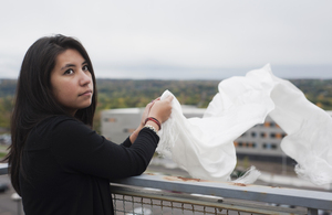 Tara Wyant, a junior hospitality management major, waves the scarf she will try to give to the 14th Dalai Lama at the Common Ground for Peace panel or the One World Concert. Wyant personally connects with the Dalai Lama through her father, who is from Tibet.