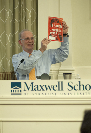 Terry Lautz, a former public policy scholar at the Woodrow Wilson International Center, holds up a copy of Time magazine during a panel discussion about miscommunication in the relationship between the United States and China on Monday in Maxwell Auditorium. 