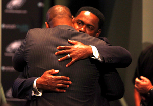 Donovan McNabb (left) and former Philadelphia Eagles safety Brian Dawkins share an emotional hug as the former Syracuse quarterback, McNabb, formally retires from professional football.