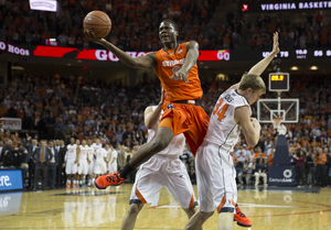 Tyler Roberson splits two Virginia defenders and finishes a layup at the end of Syracuse's 75-56 loss to Virginia on Saturday. 