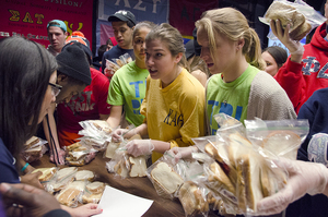 Kelli Ulhberg, a senior fashion design major, carries sandwiches in the Schine Student Center Underground during 