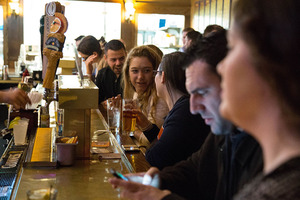 Syracuse community members are shown here enjoying drinks at a local bar.