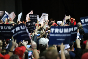 People held up signs to show their support for Donald Trump during his Saturday rally in Syracuse.