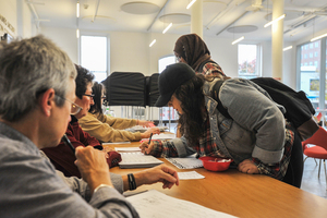 Voters sign in and collect their ballots at the polling station in Huntington Hall.