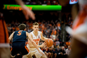 Buddy Boeheim drives left on Virginia guard Kyle Guy.