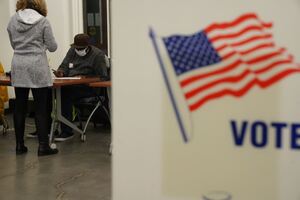 Voters sign in at the Huntington Hall polling place Tuesday morning. 