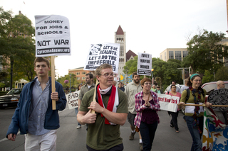 Derek Ford, a graduate student at SU and Occupy supporter, walks with fellow supporters.