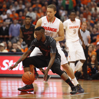 Cincinnati guard Cashmere Wright tries to get around Syracuse guard, Brandon Triche in the second half.