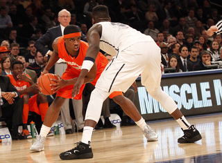 C.J. Fair dribbles the ball near the baseline, looking for an open teammate.