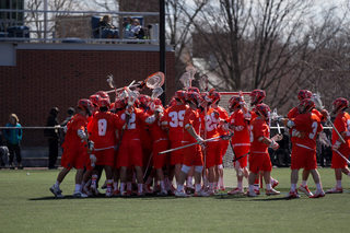 The Orange celebrates a 12-10 win over No. 3 Johns Hopkins.