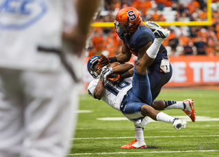 Villanova wide receiver Poppy Livers hauls in a catch despite tight coverage from a Syracuse defensive back.