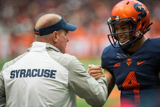 Shafer embraces Long who smiles during his first college game. The head coach was impressed with Long, which he expressed during his postgame press conference. 