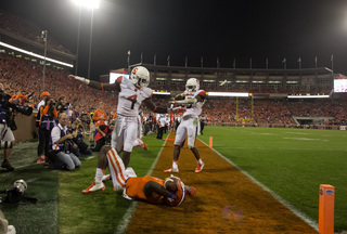 SU cornerback Brandon Reddish steps over a Clemson player out of bounds. 