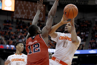 Gbinije tries to shoot over the 6-foot-10 Obekpa. The junior had four blocks. 