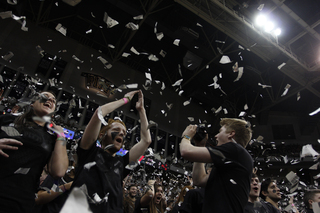 Fans throw shreds of newspaper in the air over the heads of Pittsburgh's cheerleaders.