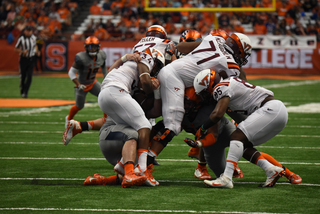 Virginia Tech players and Syracuse players collide as SU stuffs Travon McMillian, who rushed just nine times for 39 yards. 